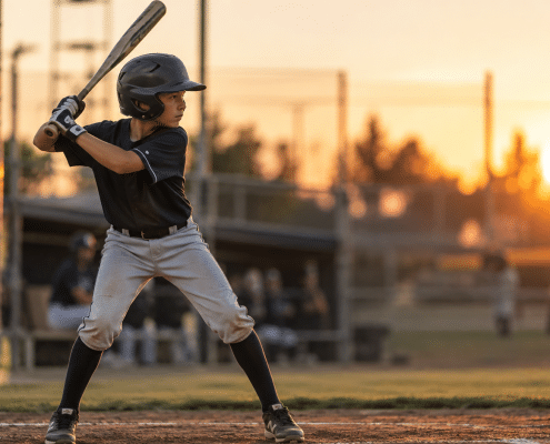 Youth baseball player demonstrating a proper baseball batting stance — balanced, hip-hinged, hands near back shoulder