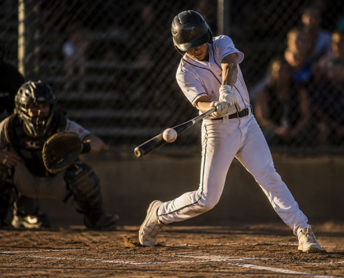 Youth baseball hitter at contact showing back foot position and hip rotation in a back foot baseball swing