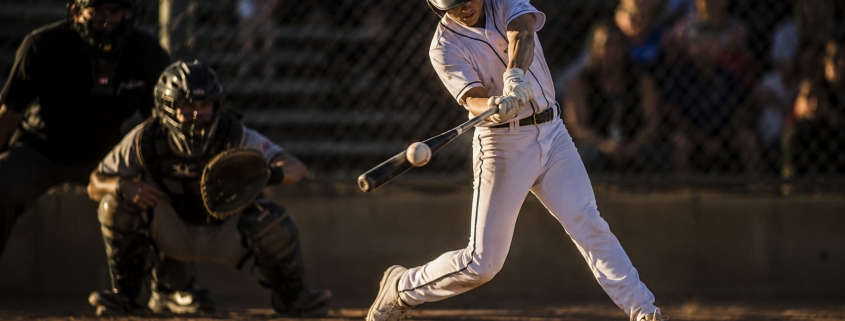 Youth baseball hitter at contact showing back foot position and hip rotation in a back foot baseball swing