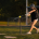 Softball player hitting off a tee with overload bat — softball hitting drills for swing mechanics