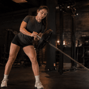 College softball player performing lateral landmine in-season workout program training
