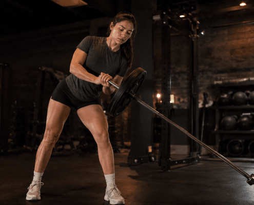 College softball player performing lateral landmine in-season workout program training
