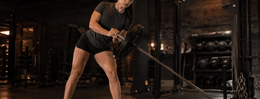College softball player performing lateral landmine in-season workout program training