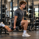 Baseball pitcher workout program — high school pitcher performing dumbbell split squat in weight room