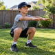 Youth baseball player doing bodyweight squat in backyard — youth baseball in-season workout program