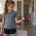 Youth softball player doing resistance band arm care exercise at home — youth softball in-season workout program